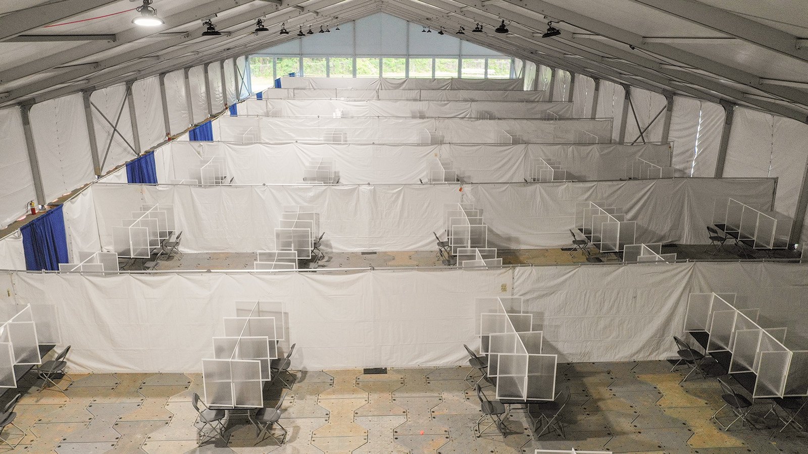 Interior of a construction tent with modular flooring and partitioned work stations